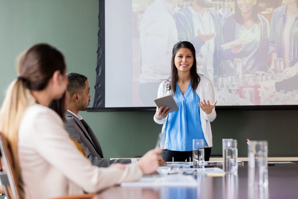 Woman leading discussion with colleagues in a conference room 