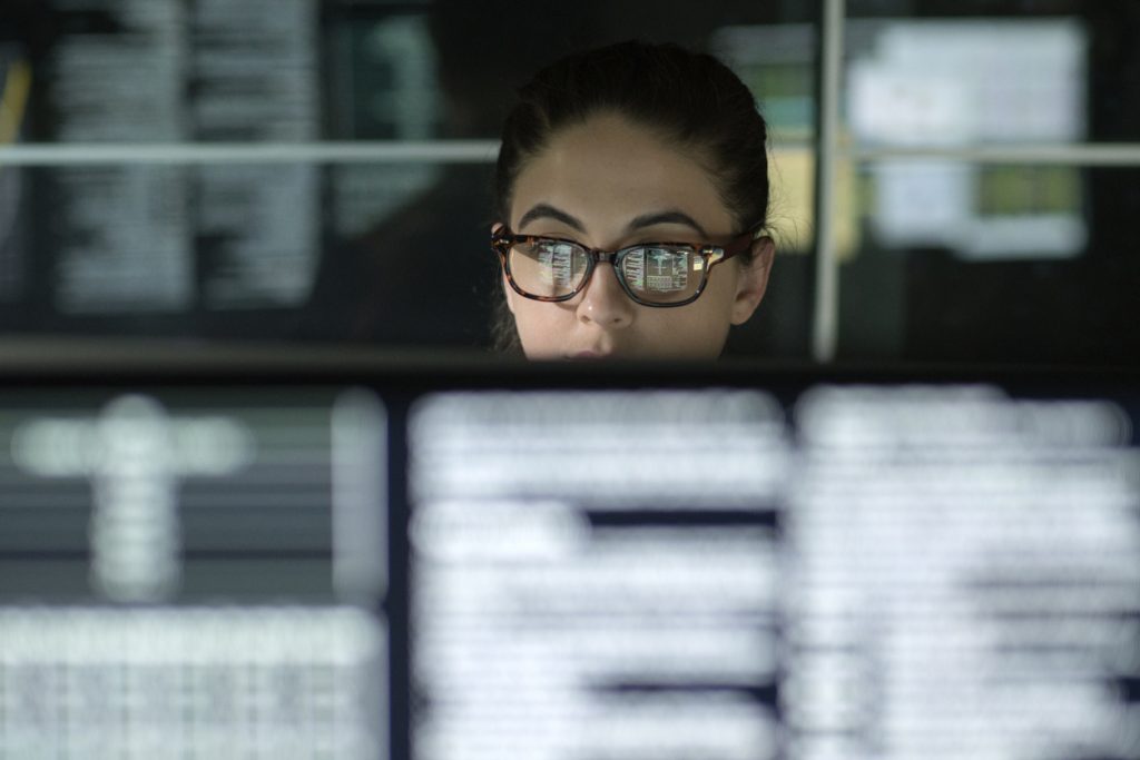 Woman looking at code on a computer