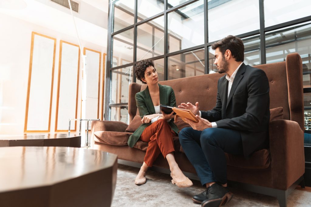 Two team members talking in office entryway