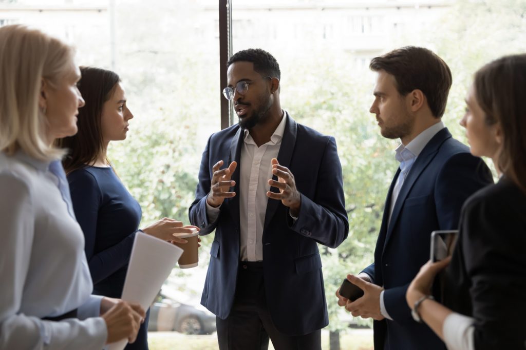 Man leading conversation with group of colleagues