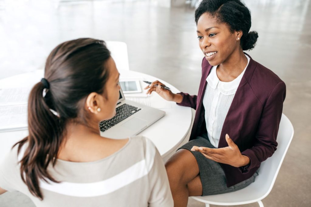 Two female colleagues talking